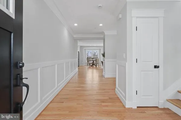 wooden floor with a chandelier