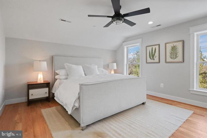 2806 Norbeck Road Silver Spring, MD 20906 - Photo 14 of 36 a bedroom with a bed chandelier and a window