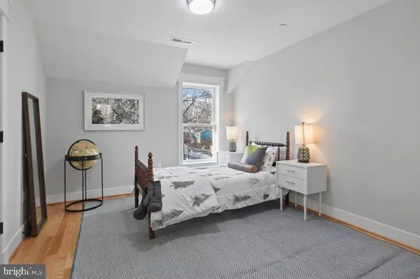 a bedroom with bed and a window