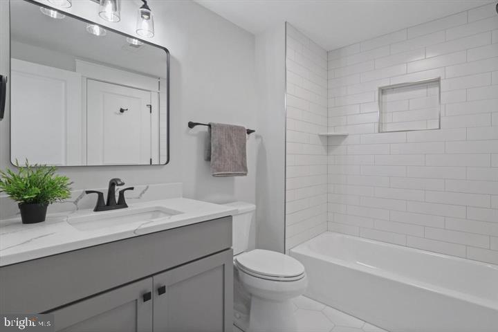 2806 Norbeck Road Silver Spring, MD 20906 - Photo 21 of 36 a bathroom with a sink a toilet and shower