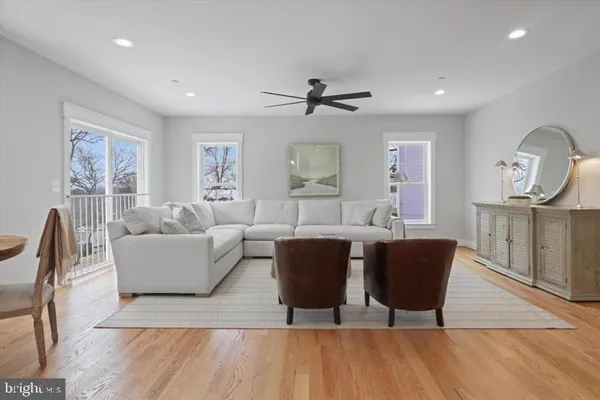 a living room with furniture a wooden floor and a chandelier