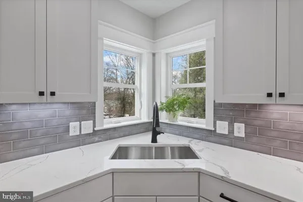 a kitchen with a sink and large window