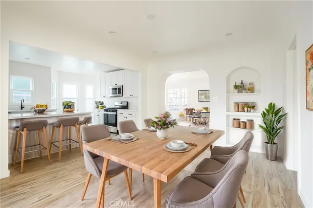 a view of a dining room with furniture and wooden floor