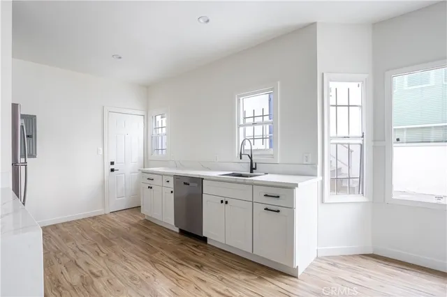 a spacious bathroom with a granite countertop sink mirror and a window