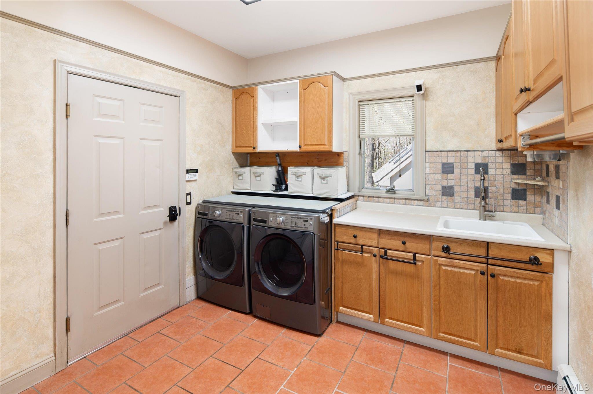 85 Orchard Hill Road Carmel, NY 10512 - Photo 14 of 50 a utility room with stainless steel appliances granite countertop a washer and dryer