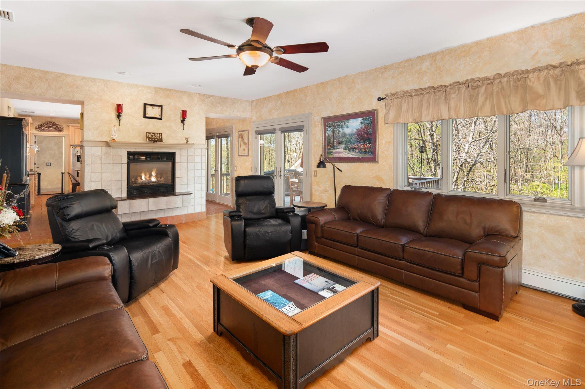 85 Orchard Hill Road Carmel, NY 10512 - Photo 17 of 50 a living room with furniture a large window with a flat screen tv and fireplace