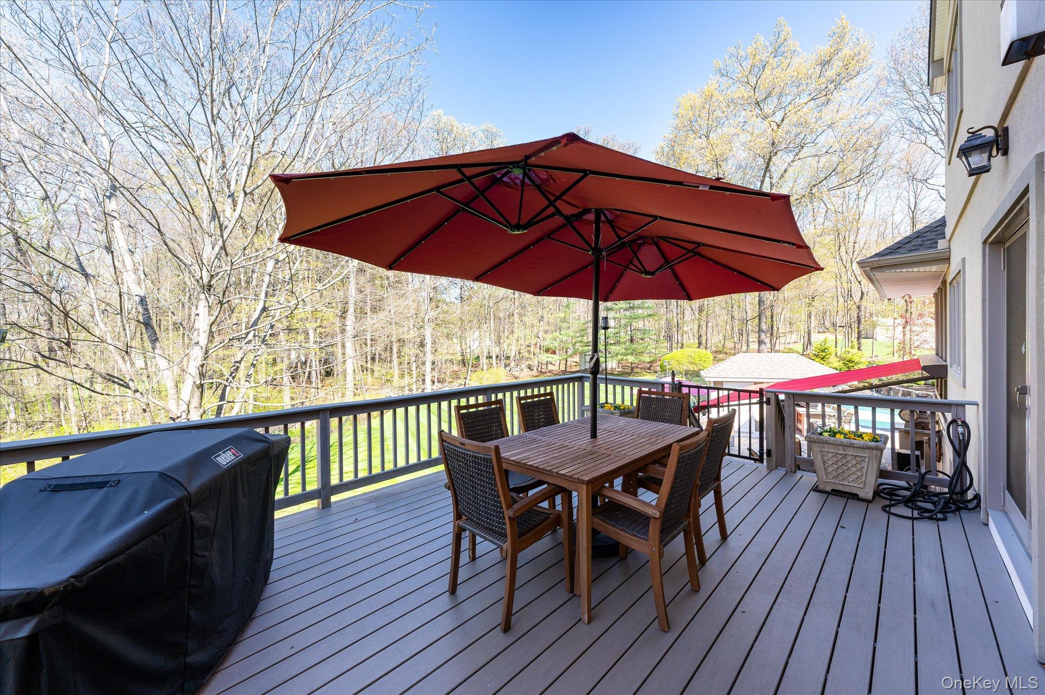 85 Orchard Hill Road Carmel, NY 10512 - Photo 18 of 50 a view of a wooden deck with furniture and umbrella