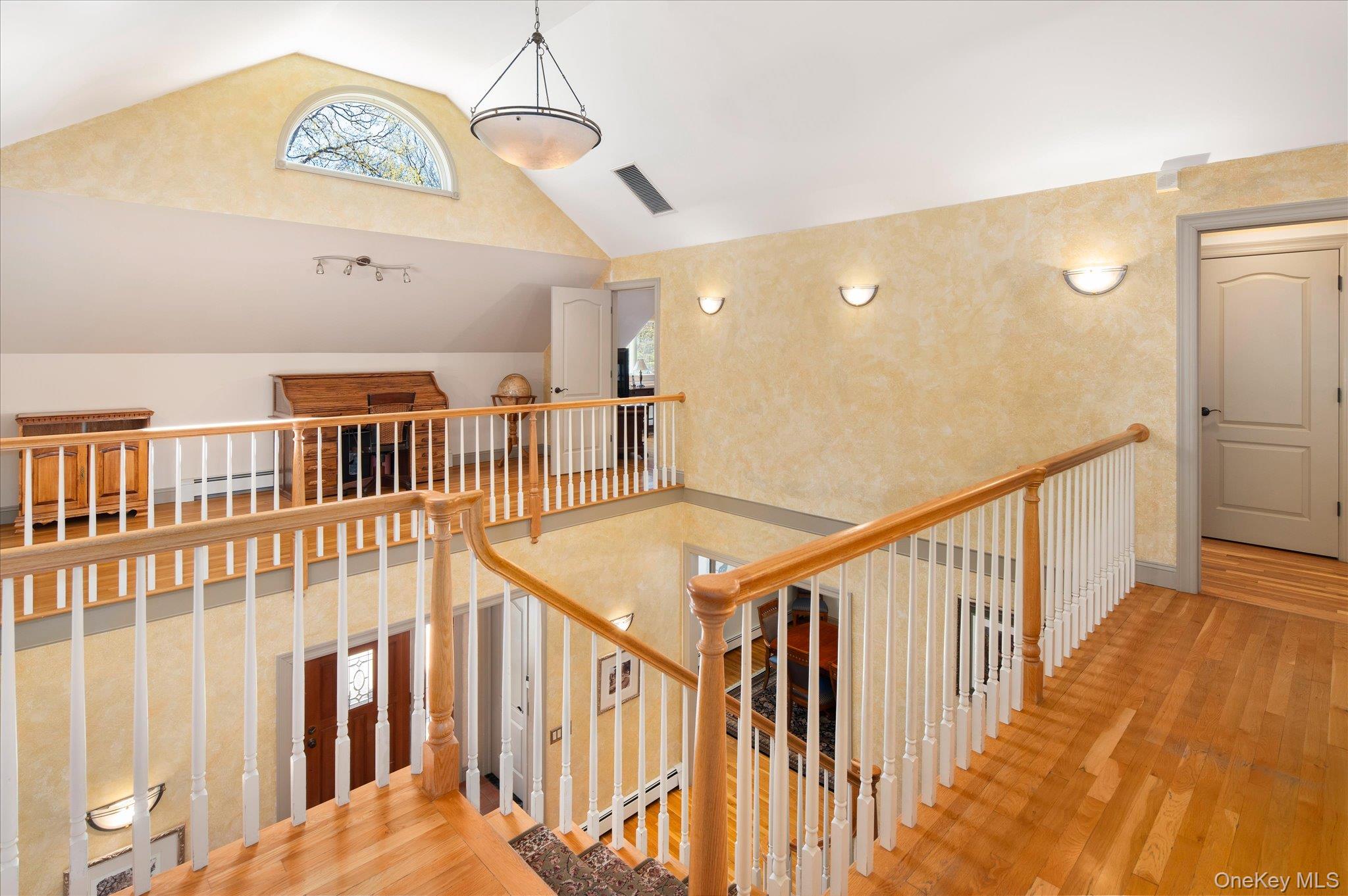 85 Orchard Hill Road Carmel, NY 10512 - Photo 22 of 50 a view of staircase with lots of frames on wall and a large window