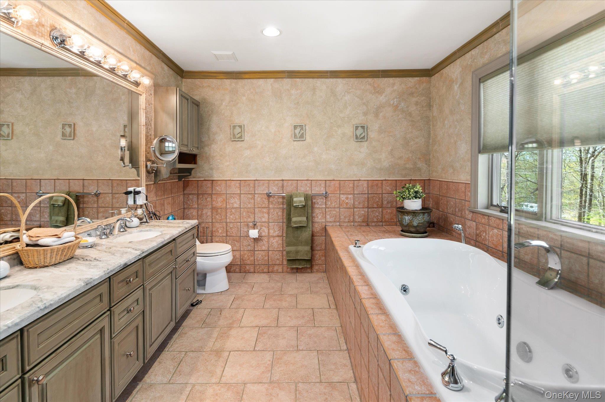 85 Orchard Hill Road Carmel, NY 10512 - Photo 26 of 50 a bathroom with a tub sink toilet and mirror
