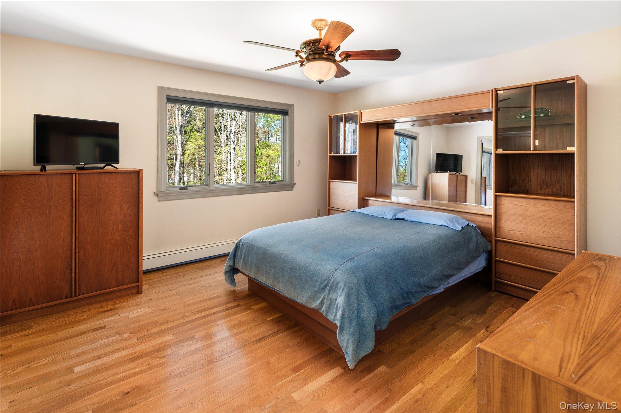 85 Orchard Hill Road Carmel, NY 10512 - Photo 29 of 50 a bedroom with a bed and a flat screen tv