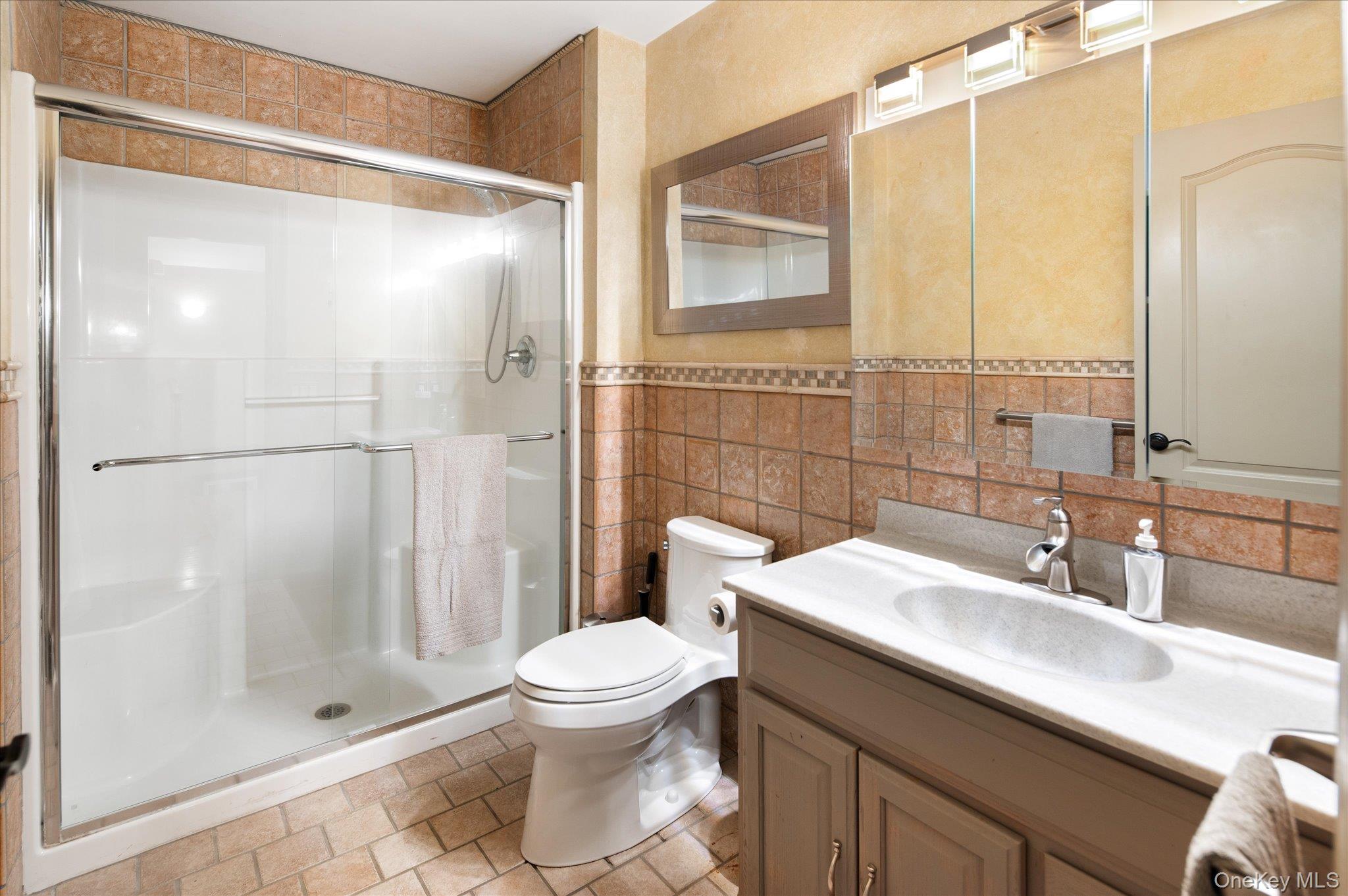 85 Orchard Hill Road Carmel, NY 10512 - Photo 30 of 50 a bathroom with a sink a toilet and shower