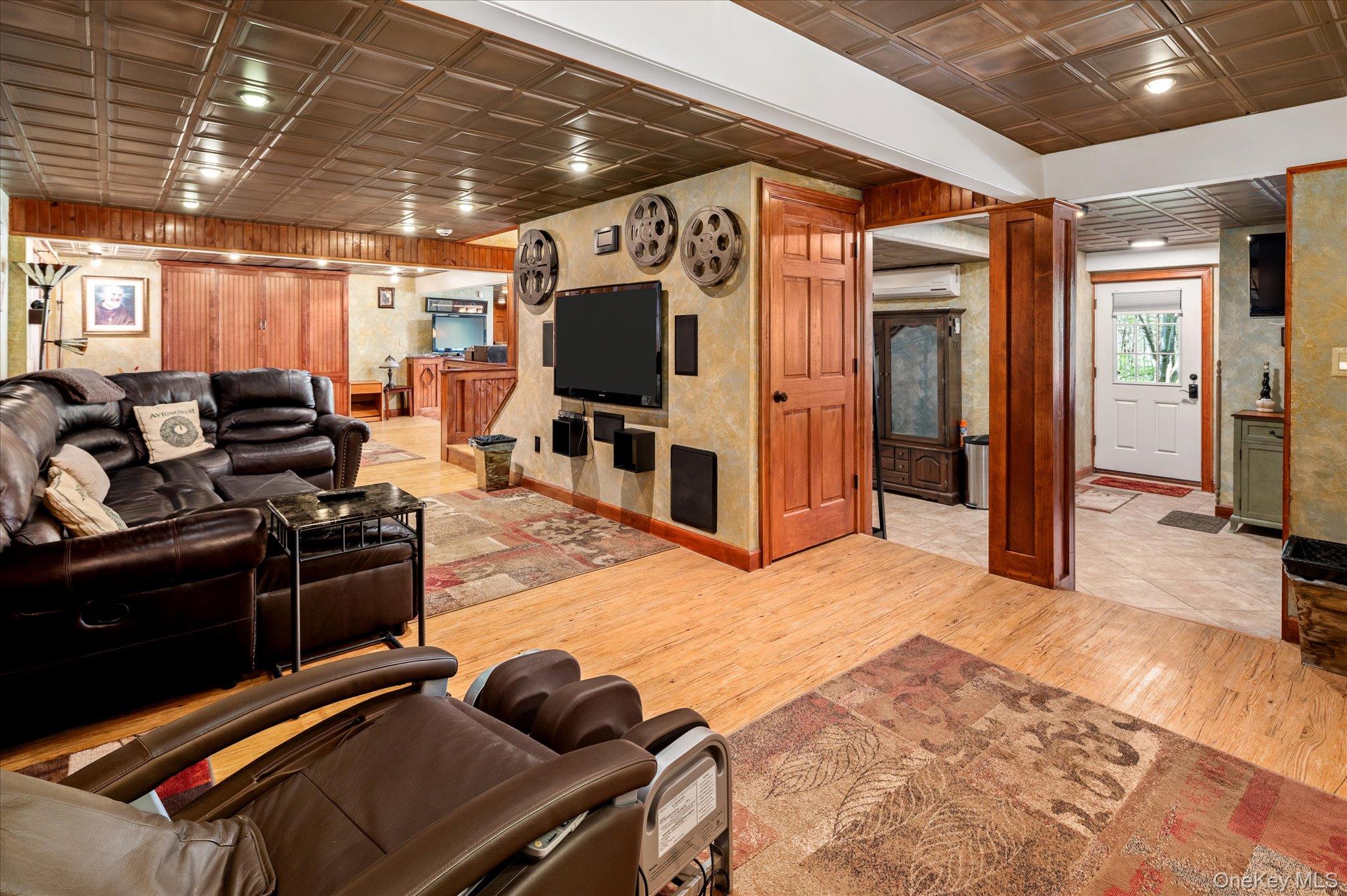 85 Orchard Hill Road Carmel, NY 10512 - Photo 33 of 50 a living room with furniture a flat screen tv and a refrigerator
