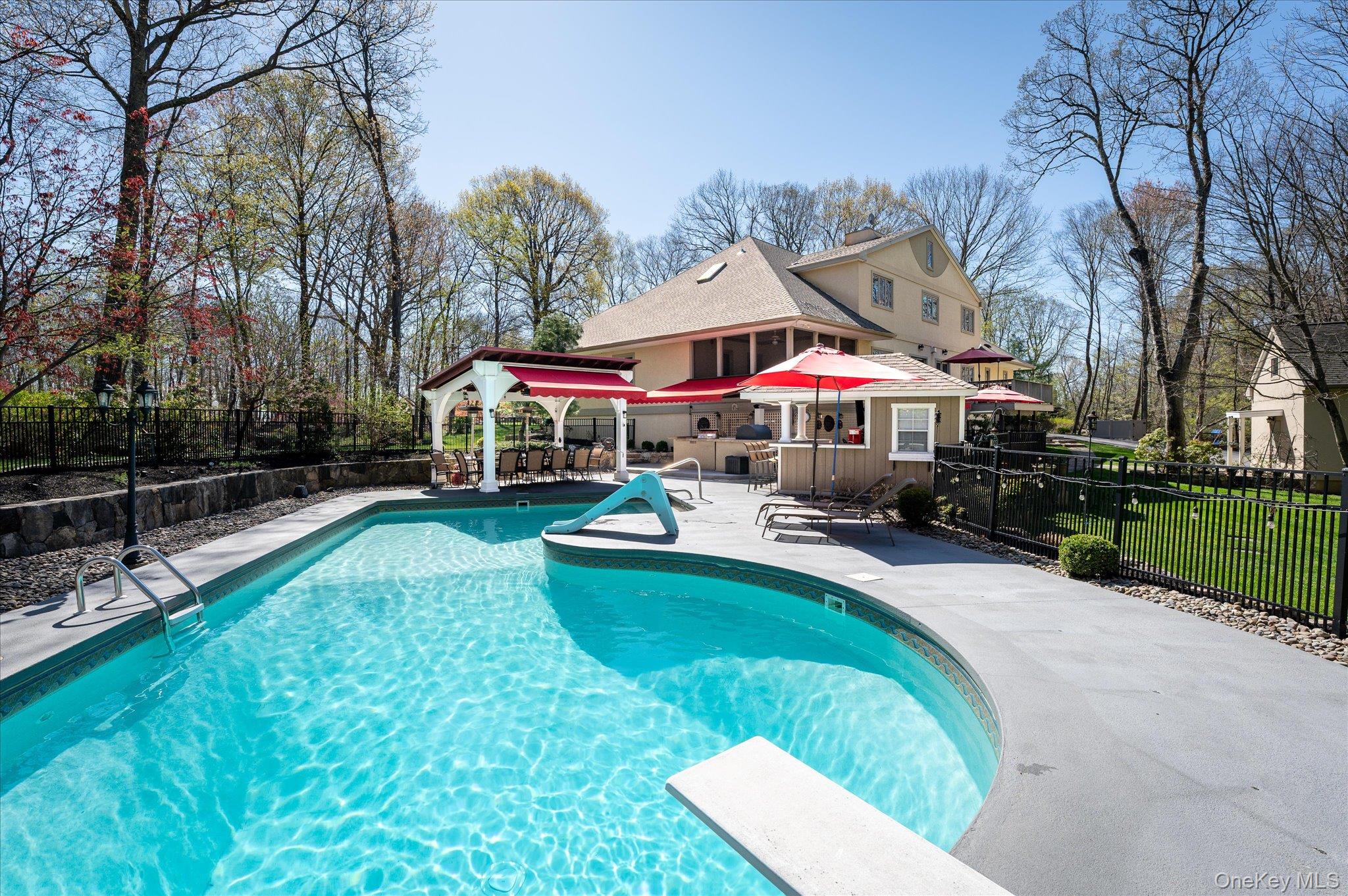 85 Orchard Hill Road Carmel, NY 10512 - Photo 40 of 50 a swimming pool with patio outdoor seating and yard in the back