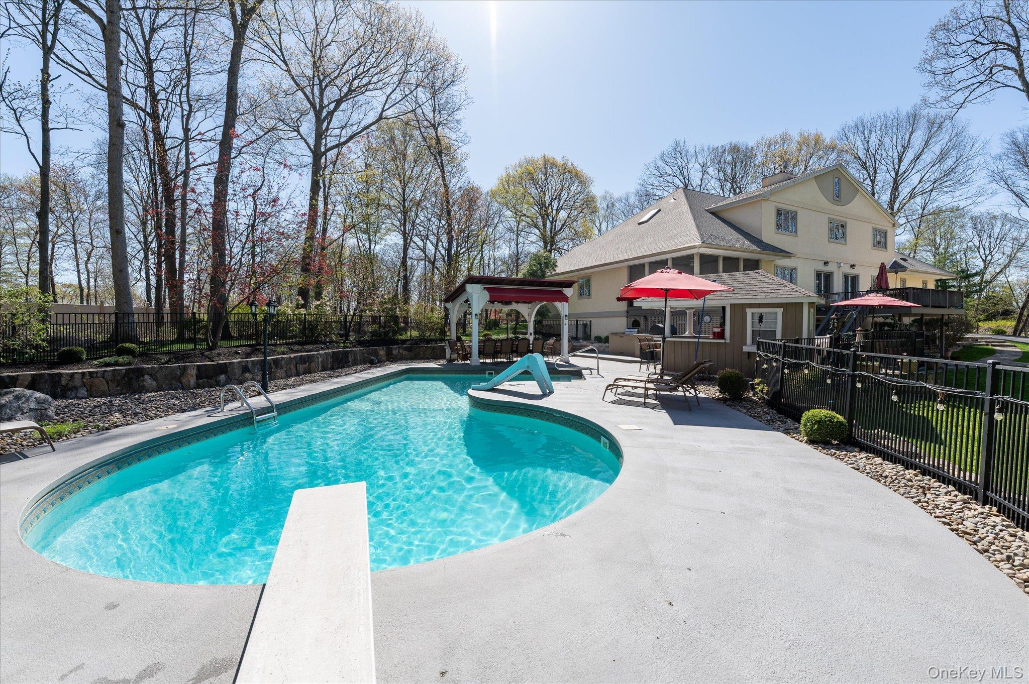 85 Orchard Hill Road Carmel, NY 10512 - Photo 4 of 50 a swimming pool with outdoor seating and yard