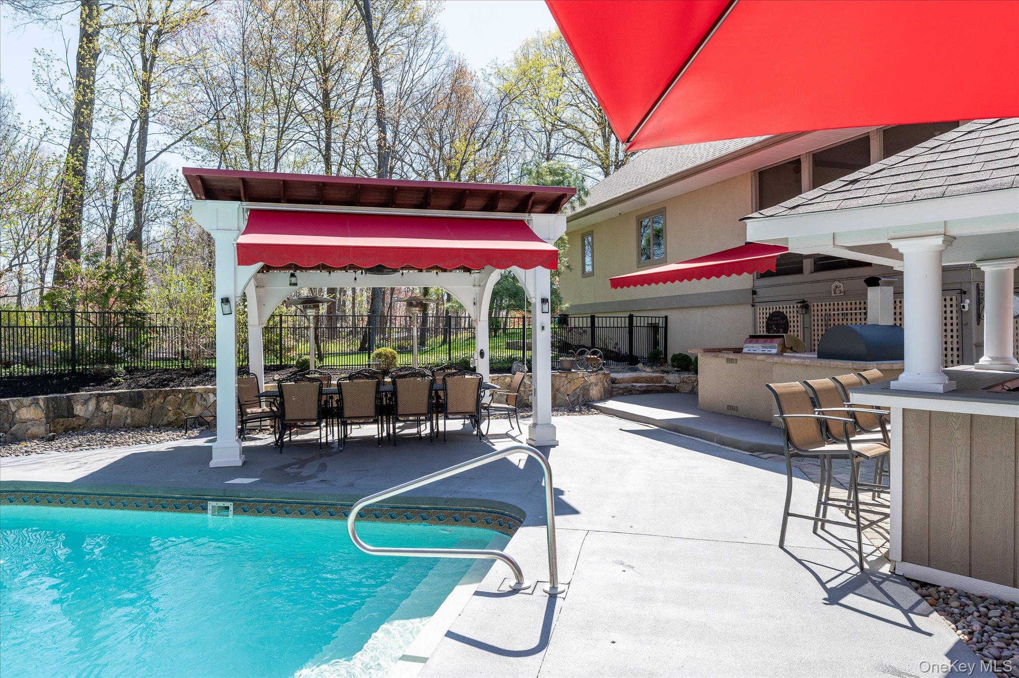85 Orchard Hill Road Carmel, NY 10512 - Photo 42 of 50 a view of a patio with a table and chairs under an umbrella