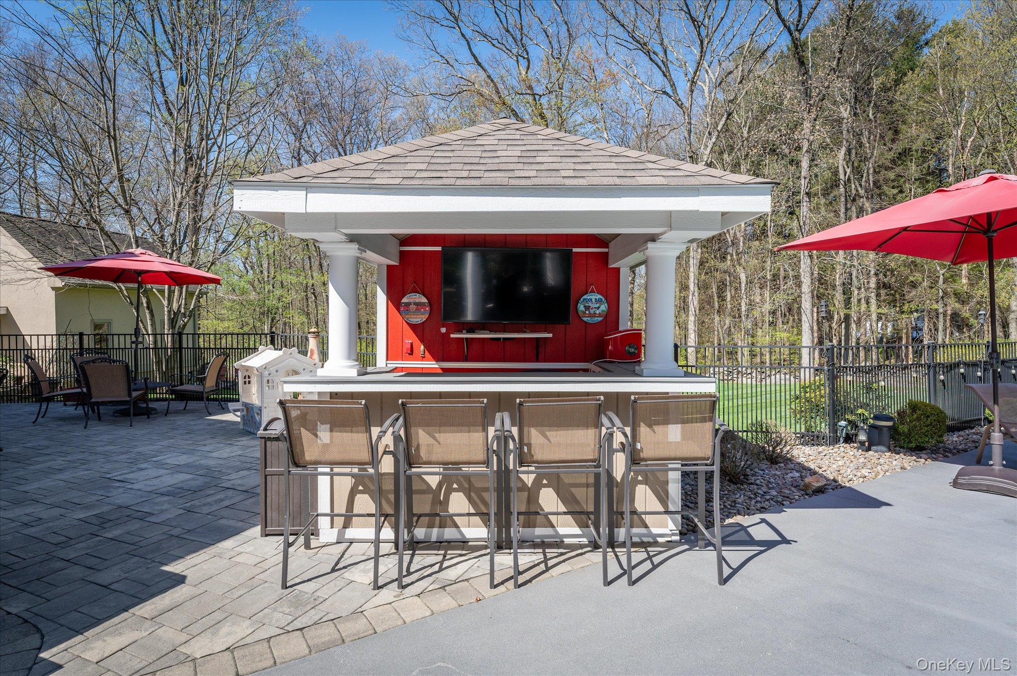 85 Orchard Hill Road Carmel, NY 10512 - Photo 43 of 50 a view of a patio with a table and chairs under an umbrella