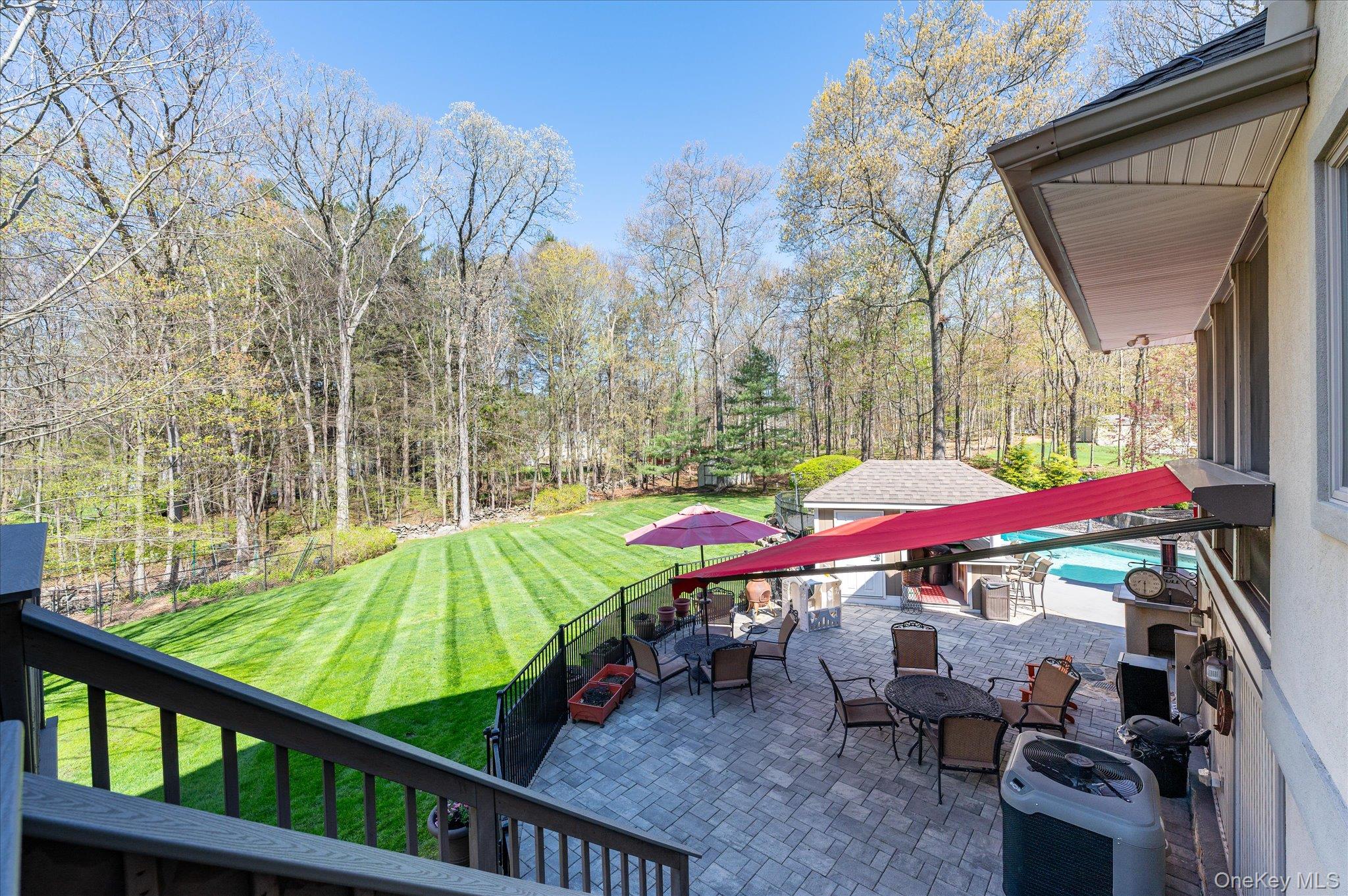 85 Orchard Hill Road Carmel, NY 10512 - Photo 45 of 50 a view of a chairs and table under an umbrella