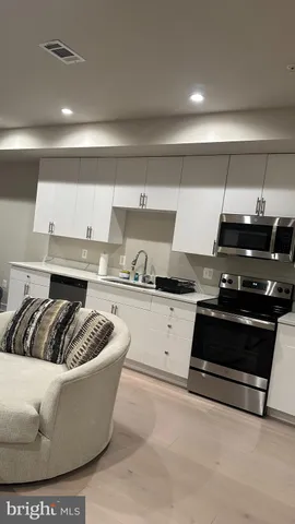 a kitchen with stainless steel appliances granite countertop a stove and a refrigerator
