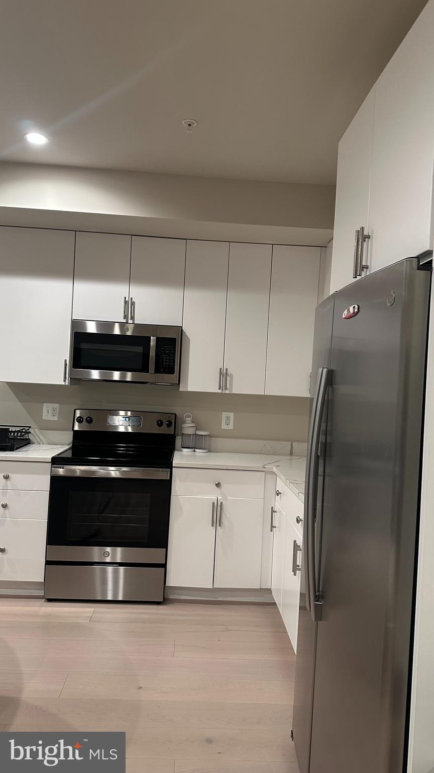 235 Valley Avenue Southeast Washington, DC 20032 - Photo 15 of 20 a kitchen with stainless steel appliances granite countertop a stove and a refrigerator