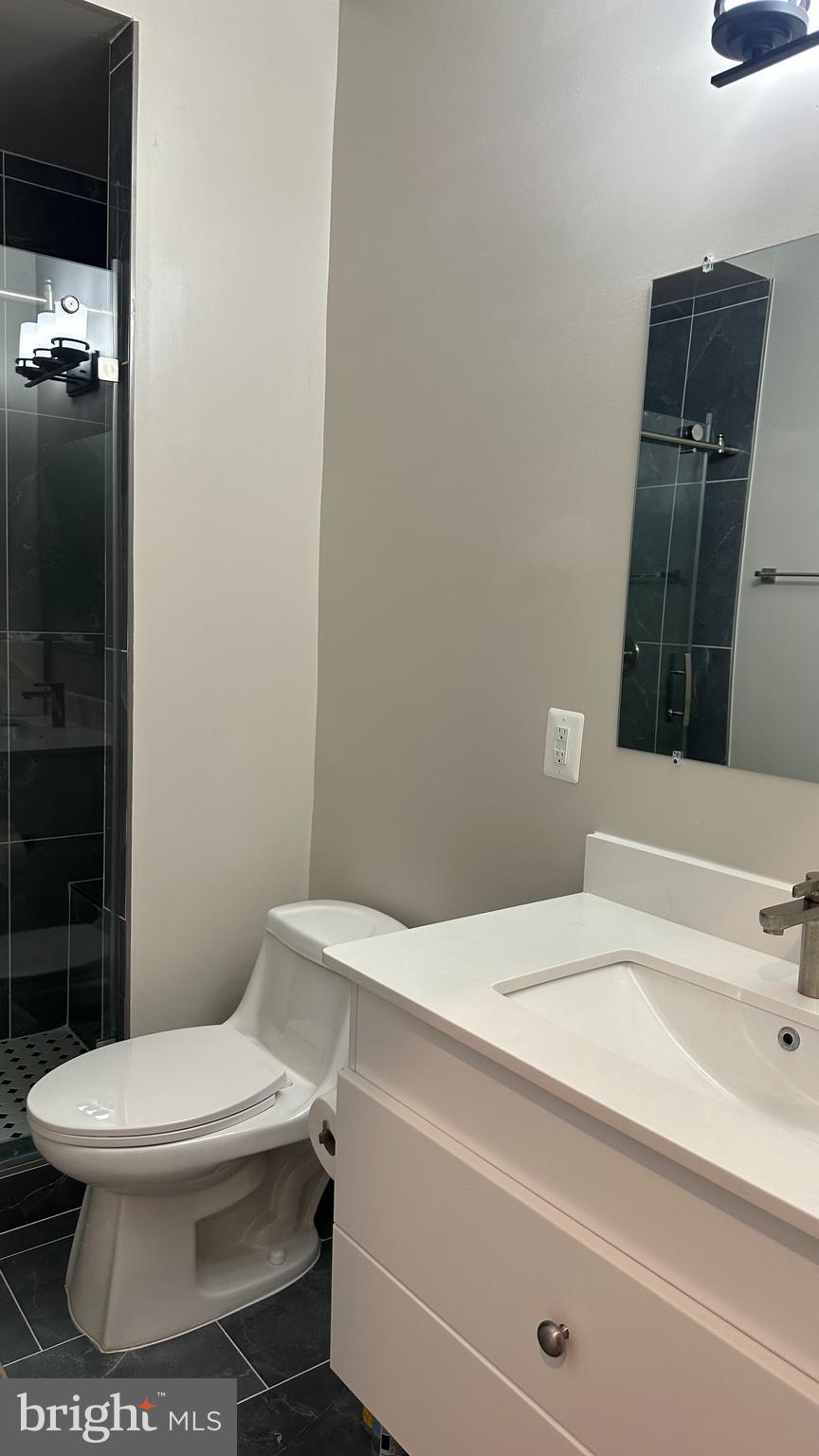 235 Valley Avenue Southeast Washington, DC 20032 - Photo 16 of 20 a bathroom with a toilet and a sink
