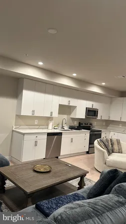 a living room with kitchen and furniture