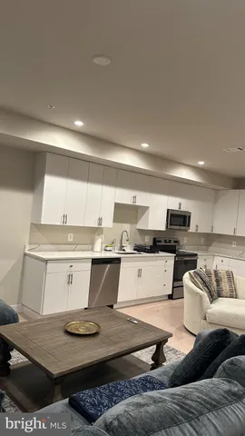 a living room with kitchen and furniture