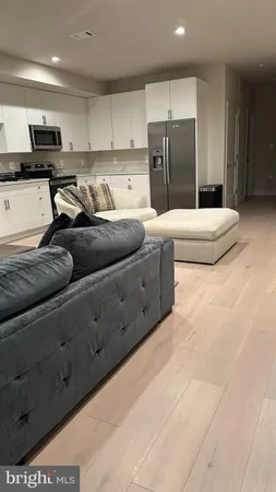 a kitchen with stainless steel appliances granite countertop a refrigerator and a stove