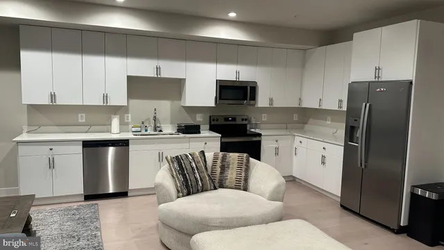 a kitchen with a refrigerator stove top oven and sink