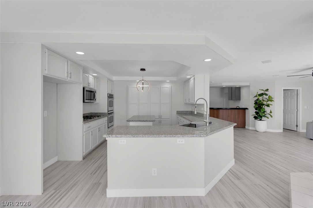 3604 North Campbell Road Las Vegas, NV 89129 - Photo 17 of 54 Kitchen featuring a sink, appliances with stainless steel finishes, recessed lighting, a tray ceiling, and white cabinets