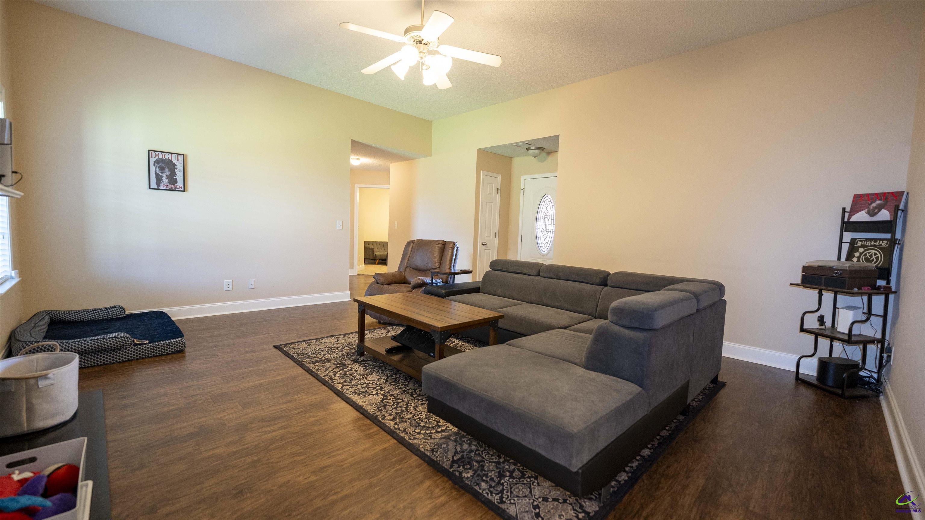 311 Sugarloaf Parkway Perry, GA 31069 - Photo 7 of 31 a living room with furniture and a book shelf