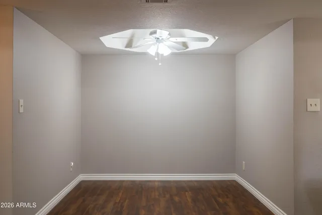 a room with a hanging light and a window
