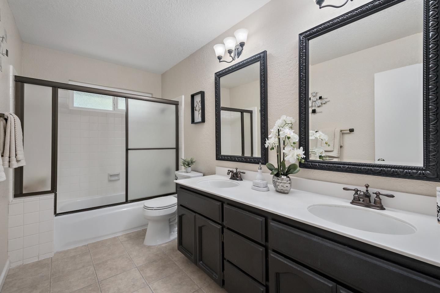 7054 Morecambe Drive San Jose, CA 95120 - Photo 18 of 50 a bathroom with a double vanity sink mirror and toilet