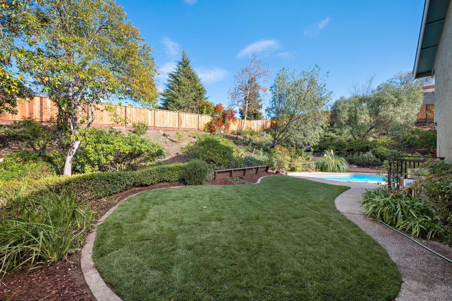 7054 Morecambe Drive San Jose, CA 95120 - Photo 2 of 50 a view of a garden with a building in the background