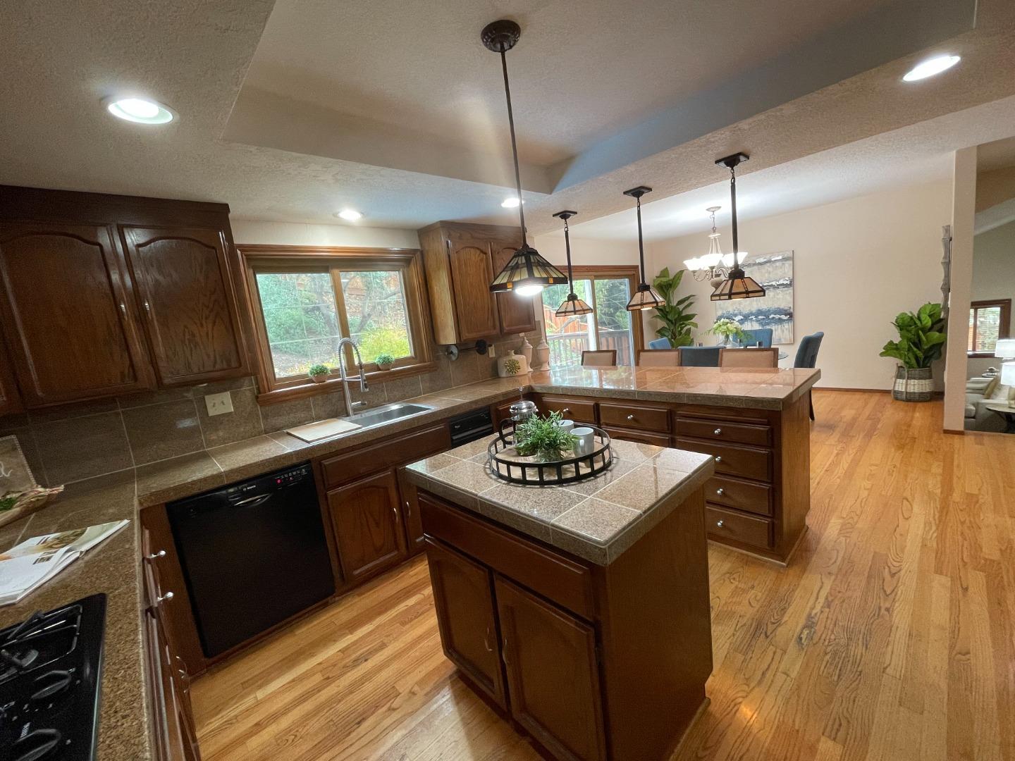7054 Morecambe Drive San Jose, CA 95120 - Photo 21 of 50 a kitchen with a sink stove and wooden floor