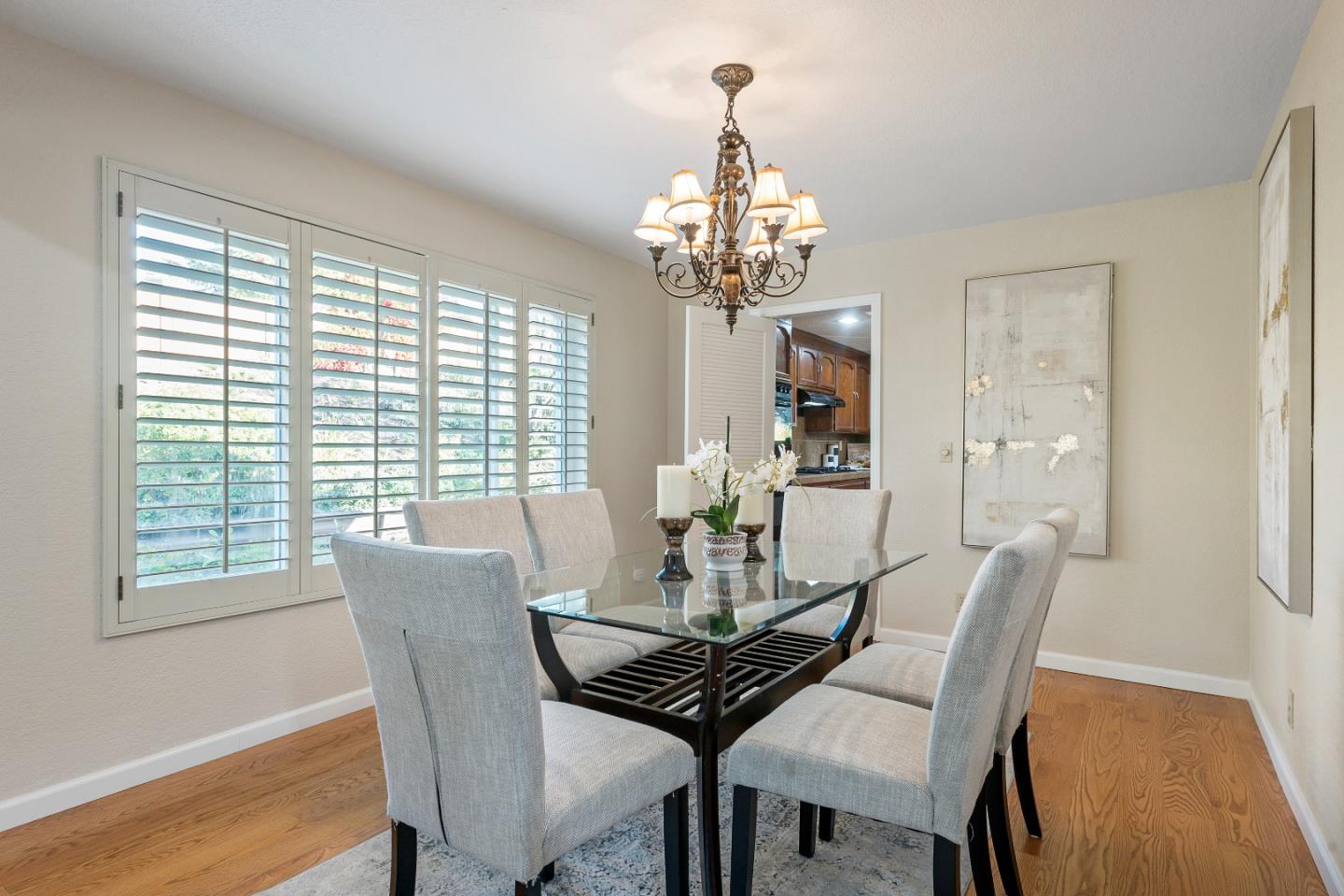 7054 Morecambe Drive San Jose, CA 95120 - Photo 43 of 50 a view of a dining room with furniture wooden floor and chandelier
