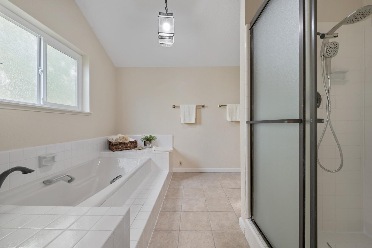 7054 Morecambe Drive San Jose, CA 95120 - Photo 9 of 50 a bathroom with a tub a sink and a window