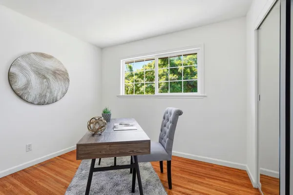 a view of a dining room with furniture and window