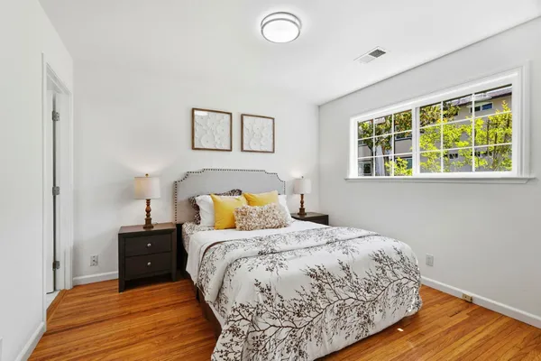 a bedroom with a bed and wooden floor
