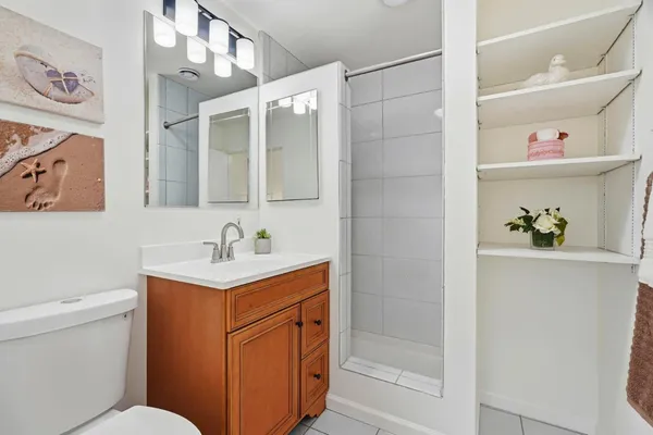 a bathroom with a sink a toilet and shower