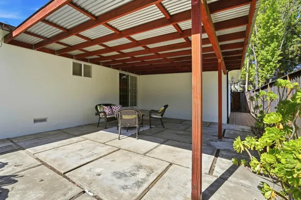 a patio with a table and chairs