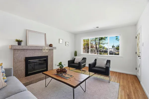 a living room with furniture and a fireplace