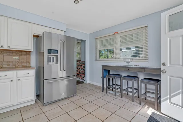 a view of room with hardwood floor ceiling fan and windows