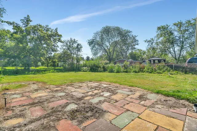 a view of a house with pool and a yard