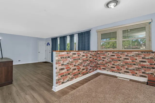 a view of wooden floor and windows in a room