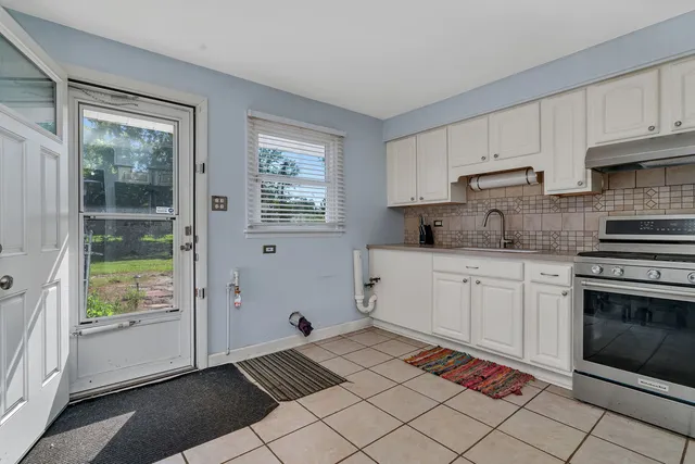 a kitchen with cabinets stainless steel appliances and a counter space