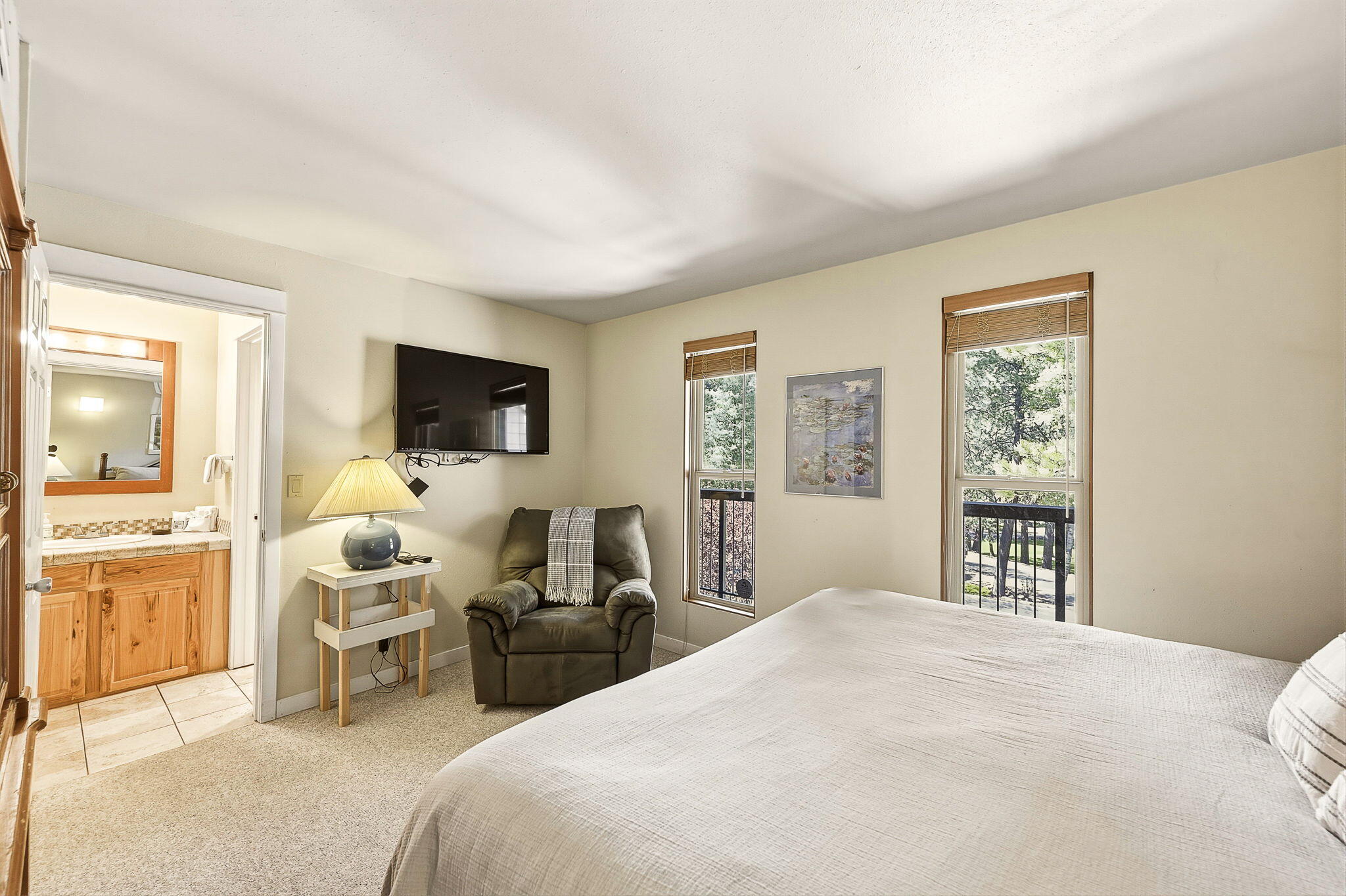 18575 Southwest Century Drive, Unit 232 Bend, OR 97702 - Photo 11 of 37 a bedroom with a bed and wooden floor