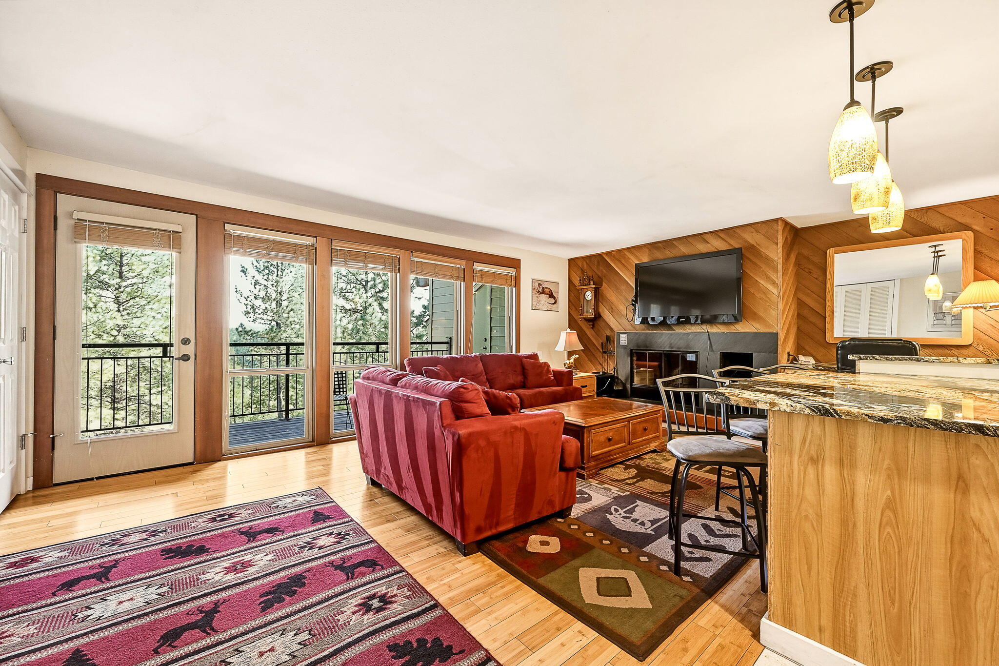 18575 Southwest Century Drive, Unit 232 Bend, OR 97702 - Photo 1 of 37 a living room with furniture a flat screen tv and a floor to ceiling window