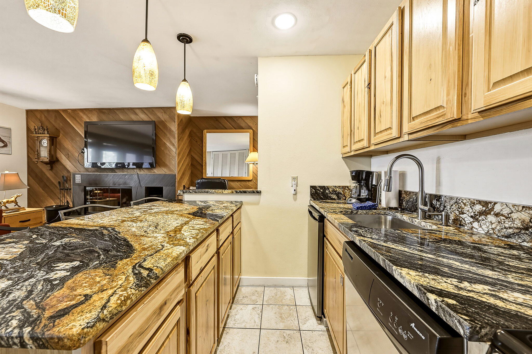 18575 Southwest Century Drive, Unit 232 Bend, OR 97702 - Photo 5 of 37 a kitchen with stainless steel appliances granite countertop a sink a stove and a wooden cabinets