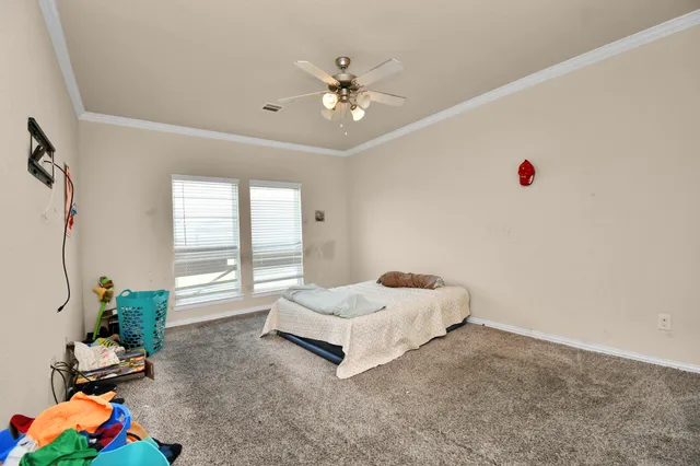 a living room with a bed furniture and a chandelier