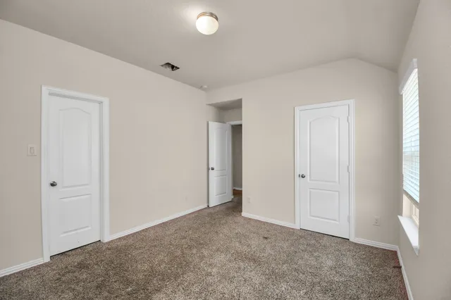 a view of an empty room and closet area